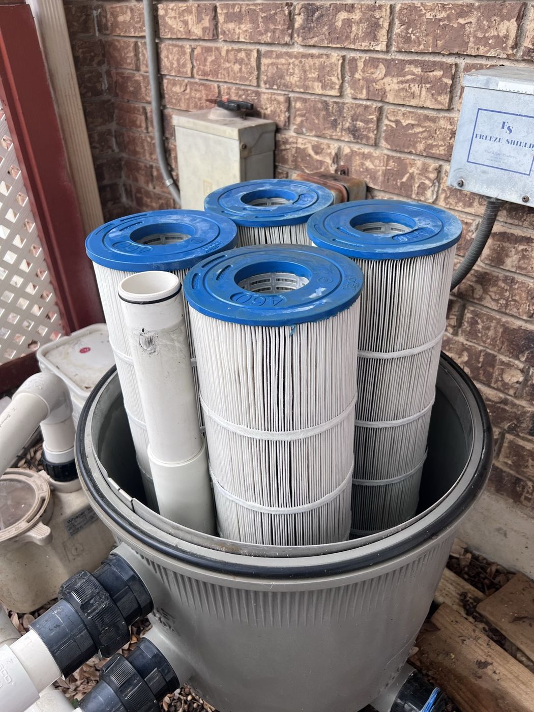 The same filter tank with its cartridges bright white after a full Blue Flag teardown clean