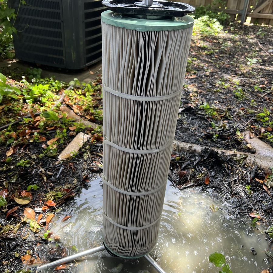 A cartridge washed element by element, dirty water pooling below