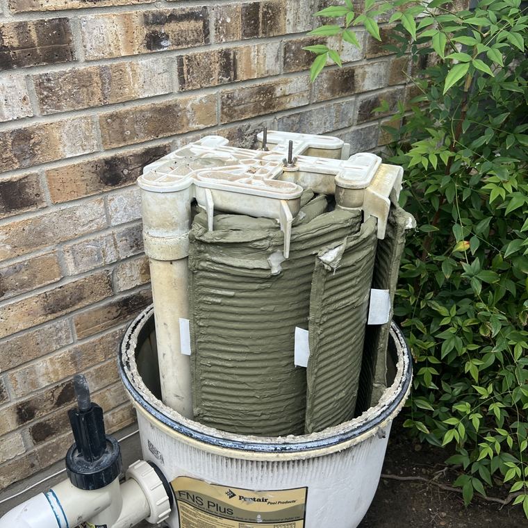 Olive-green cartridges packed inside a filter tank